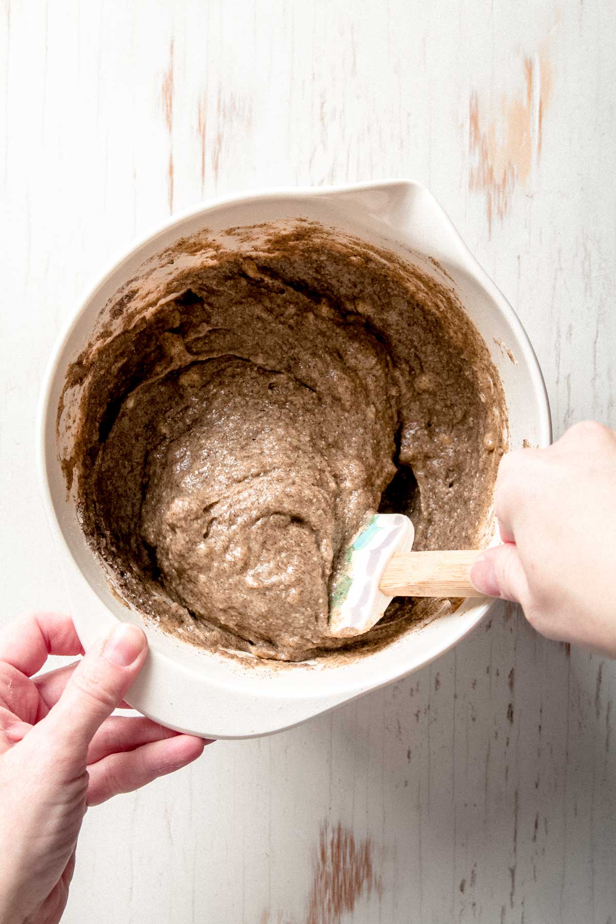 Fully mixed buckwheat banana bread batter with thick, scoopable texture in a white mixing bowl.