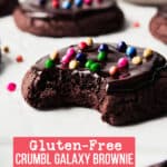 Gluten free galaxy brownie cookies, one with bite taken.