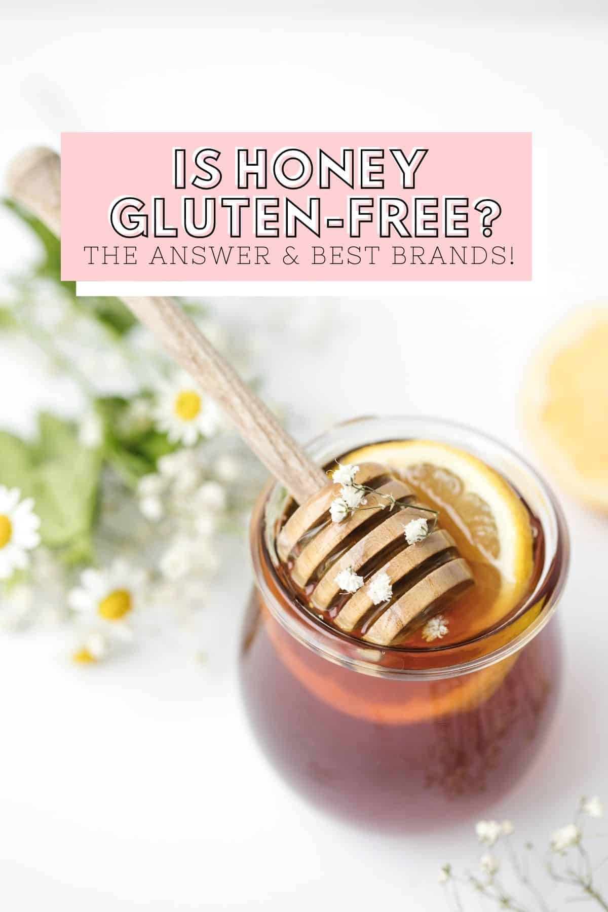 Honey in small jar with lemon slice, honey dipper, and white flowers.