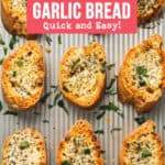 A baking sheet filled with golden brown gluten free garlic bread in rows.