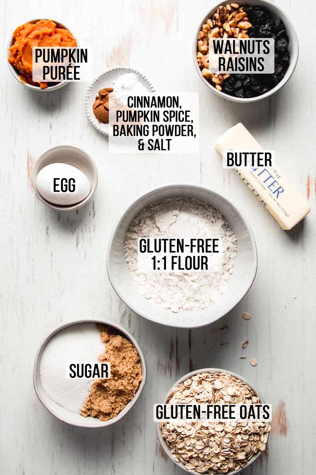 Ingredients for gluten free pumpkin oatmeal cookies measured out in bowls. 