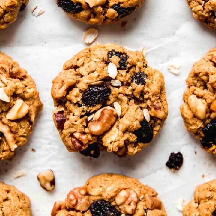 Gluten free pumpkin oatmeal cookies with raisins and walnuts peaking out the tops.