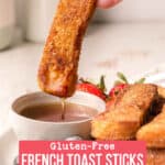 A french toast stick with syrup dripping down over a small bowl.