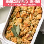 Gluten-free sage and onion stuffing baked in white casserole dish garnished with sage leaves.