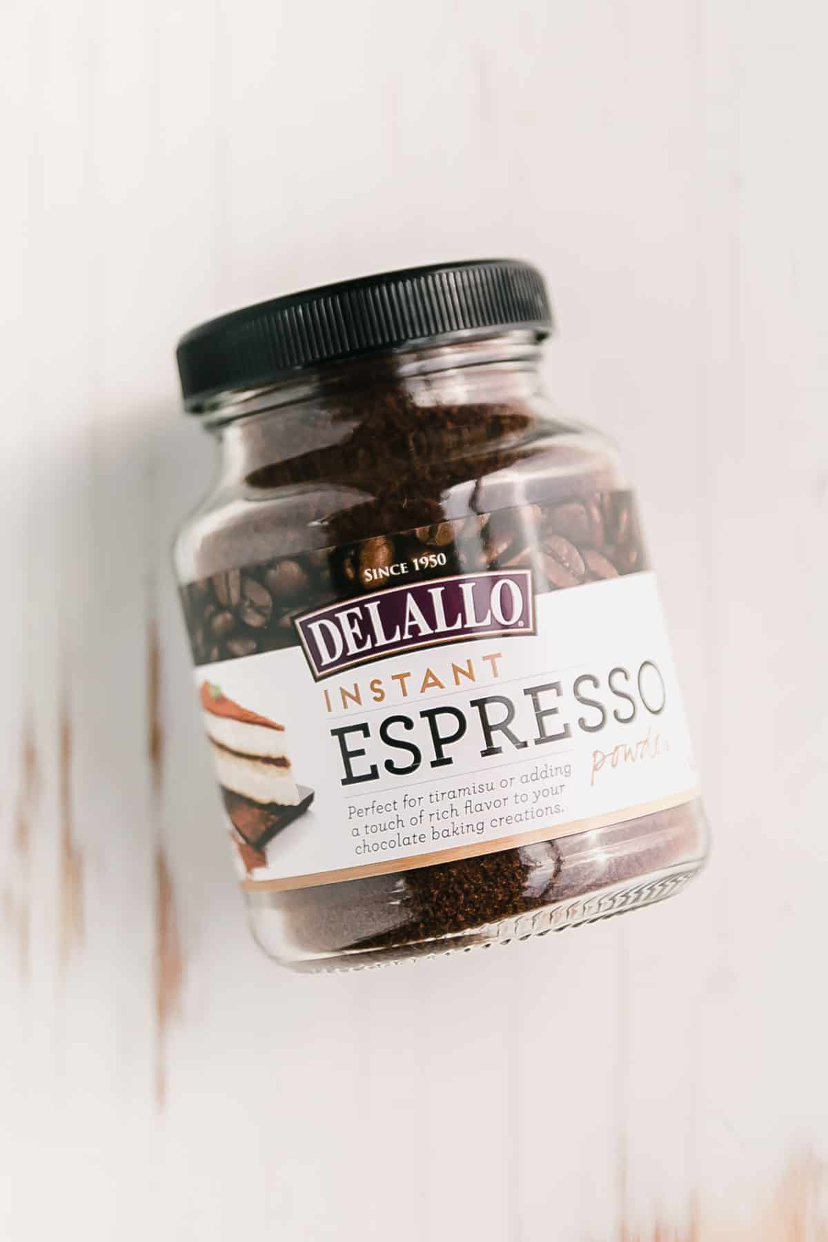 Delallo espresso powder on white surface.