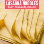 Gluten free lasagna noodles stacked on a wooden board with the corners folded over.
