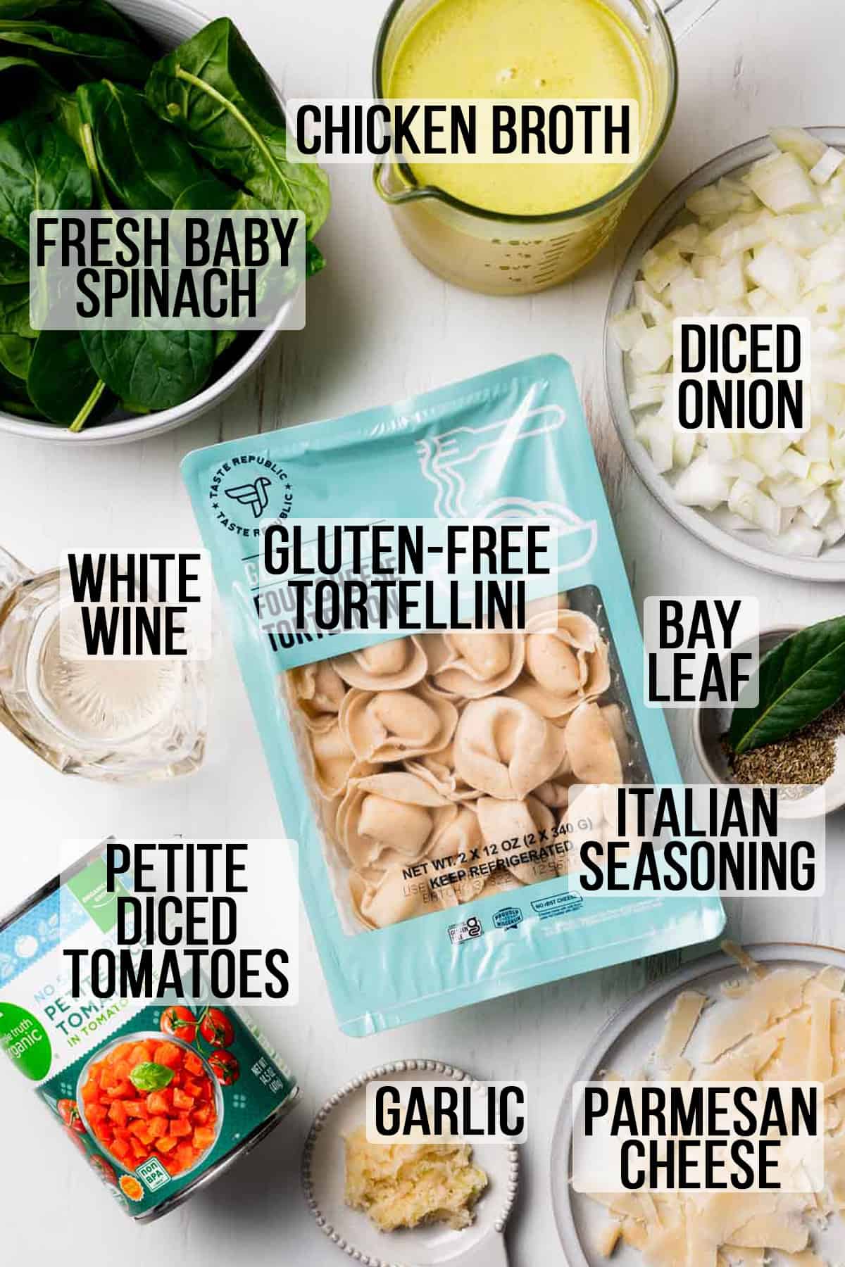 Ingredients needed for gluten free spinach tortellini soup measured in bowls on white surface.