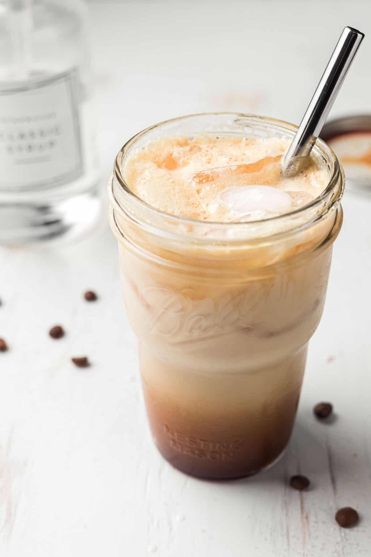 Starbucks iced shaken espresso copycat in a mason jar with metal straw.