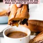 French dip sandwich dunked in a cup of gluten-free au jus.