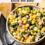 Sweet corn salsa in a small bowl next to tortilla chips.