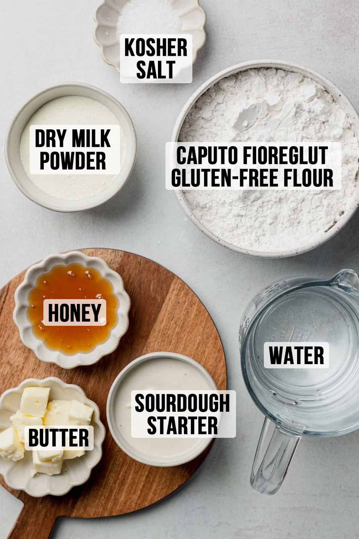 Ingredients needed to make gluten-free sourdough sandwich bread measured out in bowls, including Caputo Fioreglut.