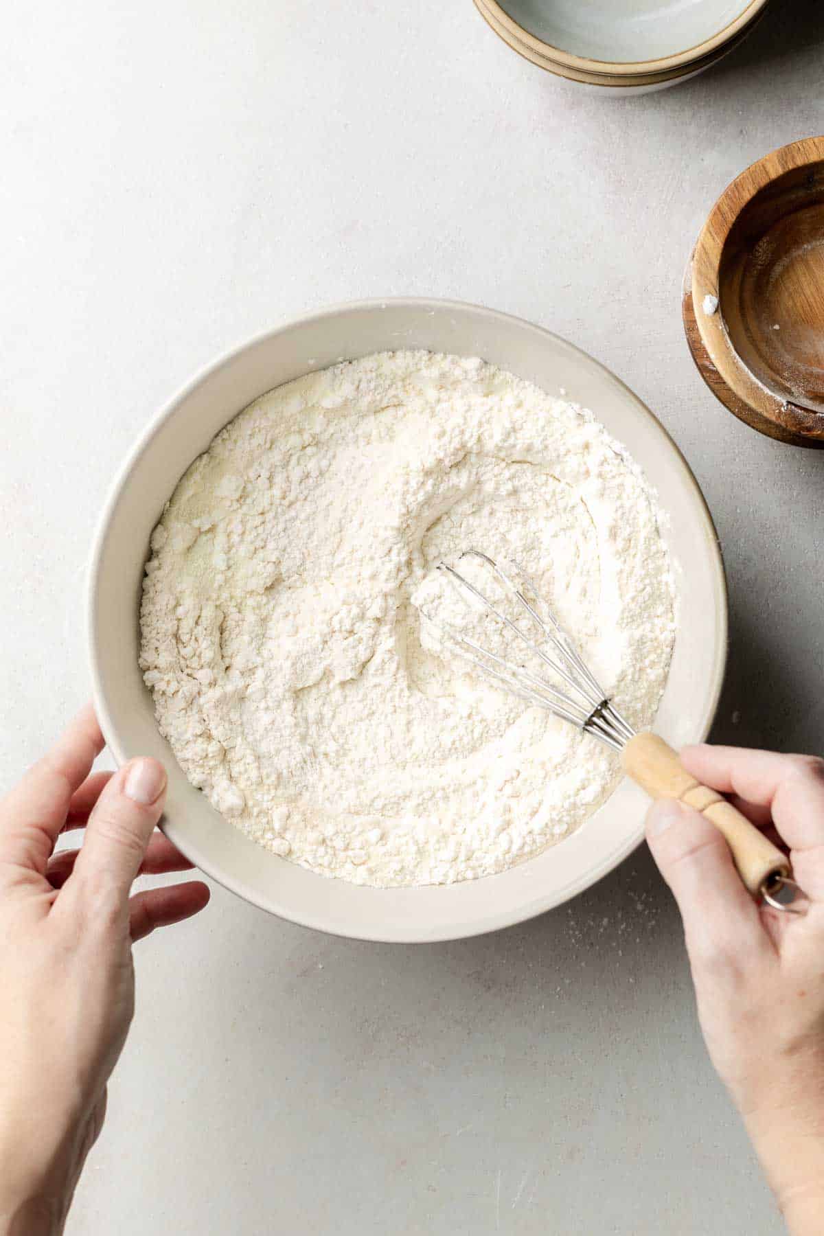 Gluten-free flour blend mixed together in large mixing bowl with whisk. 