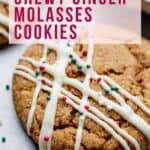 Gluten Free Ginger Molasses Cookie adorned with white chocolate and red and green sprinkles.