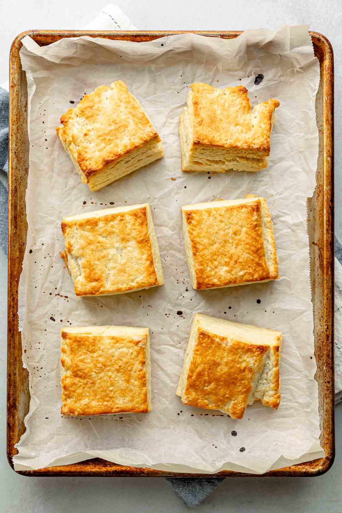 Golden brown biscuits on a baking sheet lined with parchment paper.