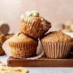 Gluten free sourdough discard banana muffins stacked on top and next to each other. One has streusel topping.