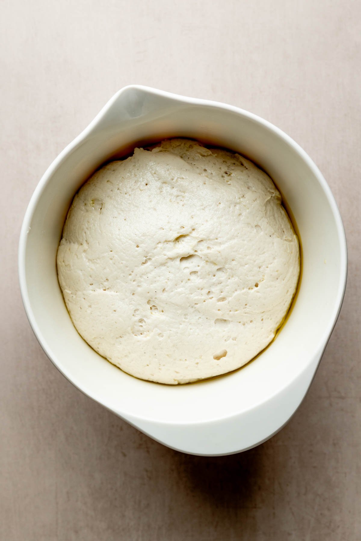 Puffed dough in bowl is doubled in size. 