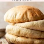 A stack of four gluten free pita breads on cutting board next to striped towel and rustic knife.