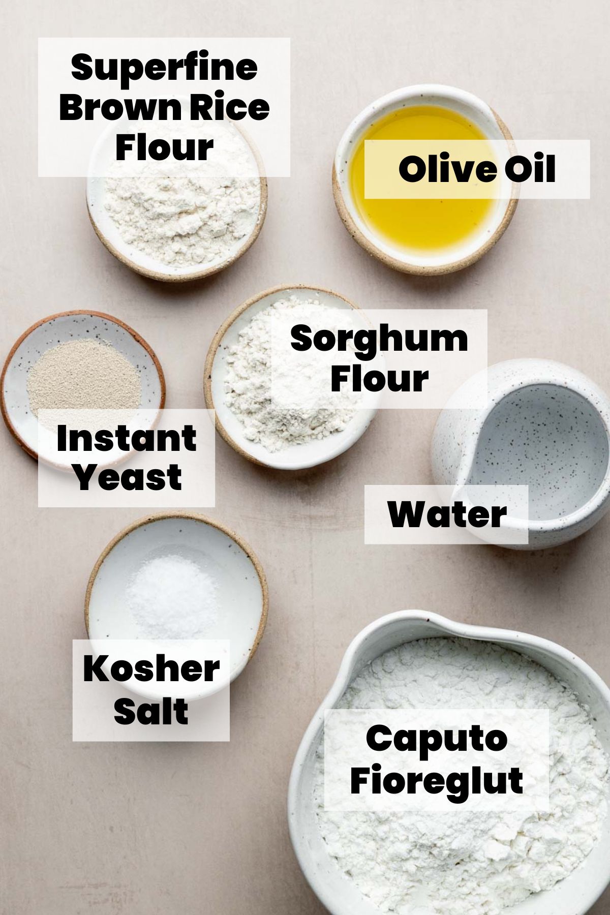 Ingredients for pita bread measured out in bowls. 