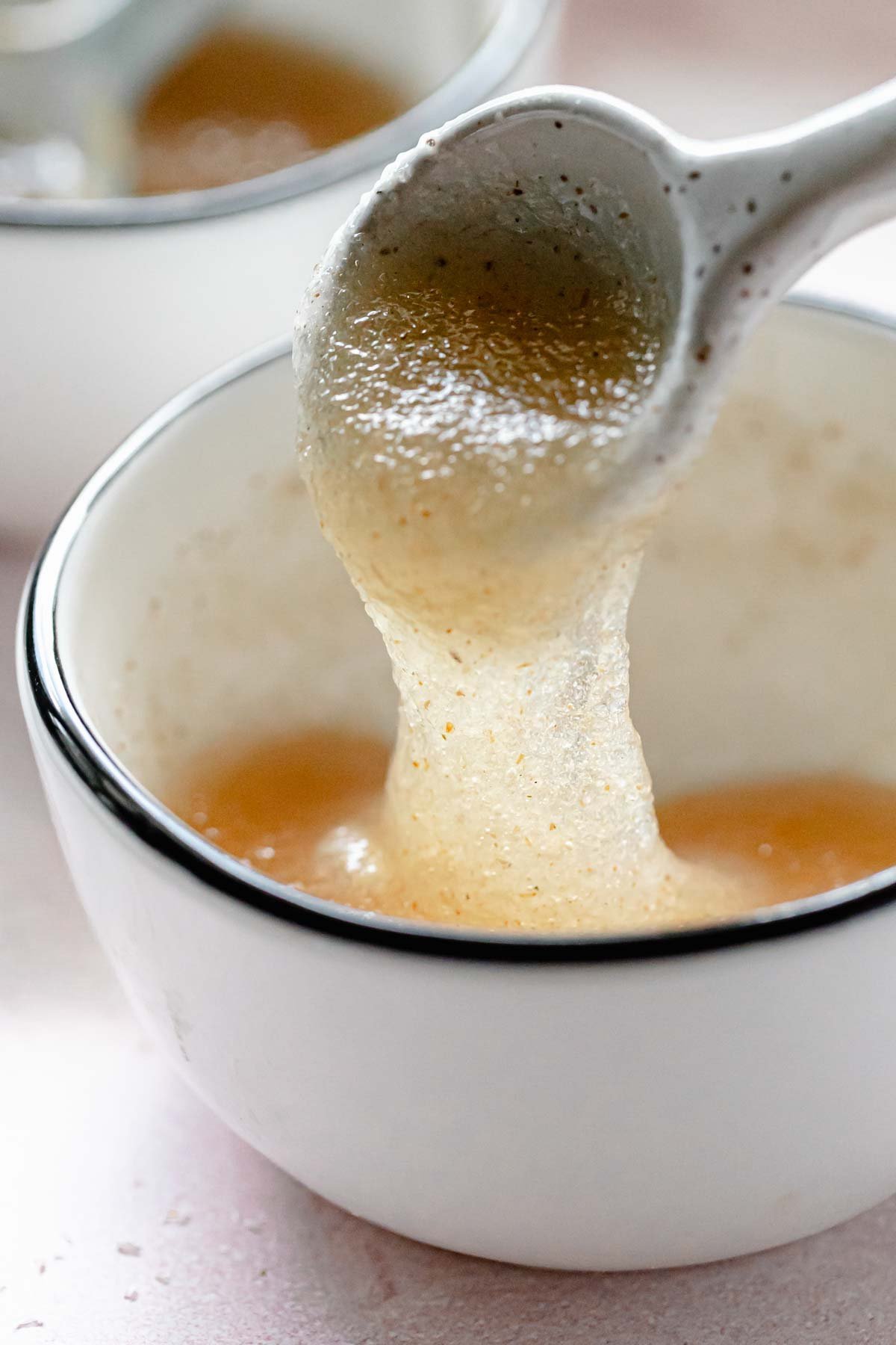Psyllium husk gel stretched from spoon back into small bowl.