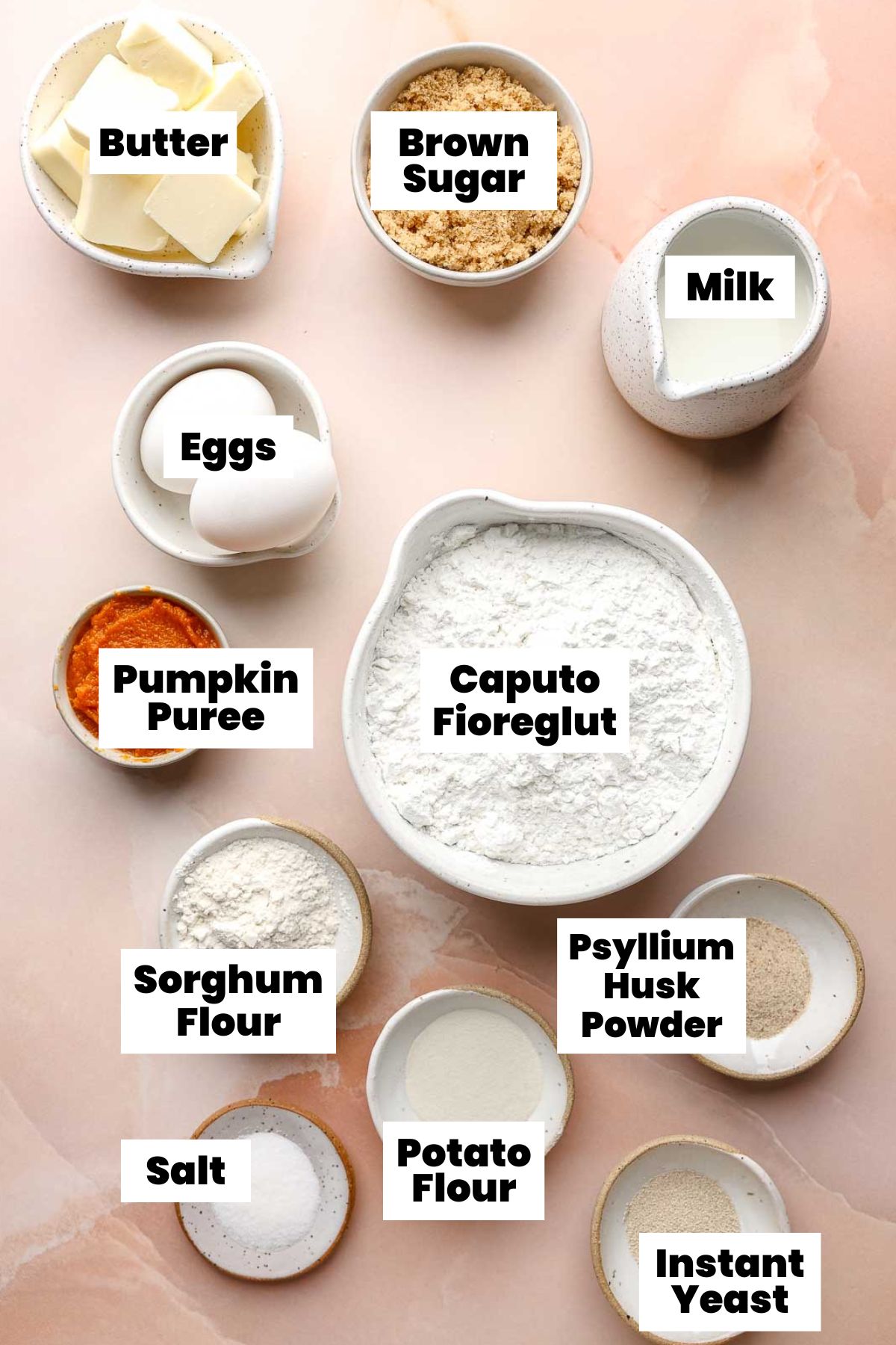 Ingredients for gluten free pumpkin cinnamon rolls measured out in bowls.