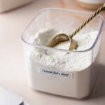 Container labeled “Copycat Bob’s Blend” filled with gluten-free flour mixture and scoop.