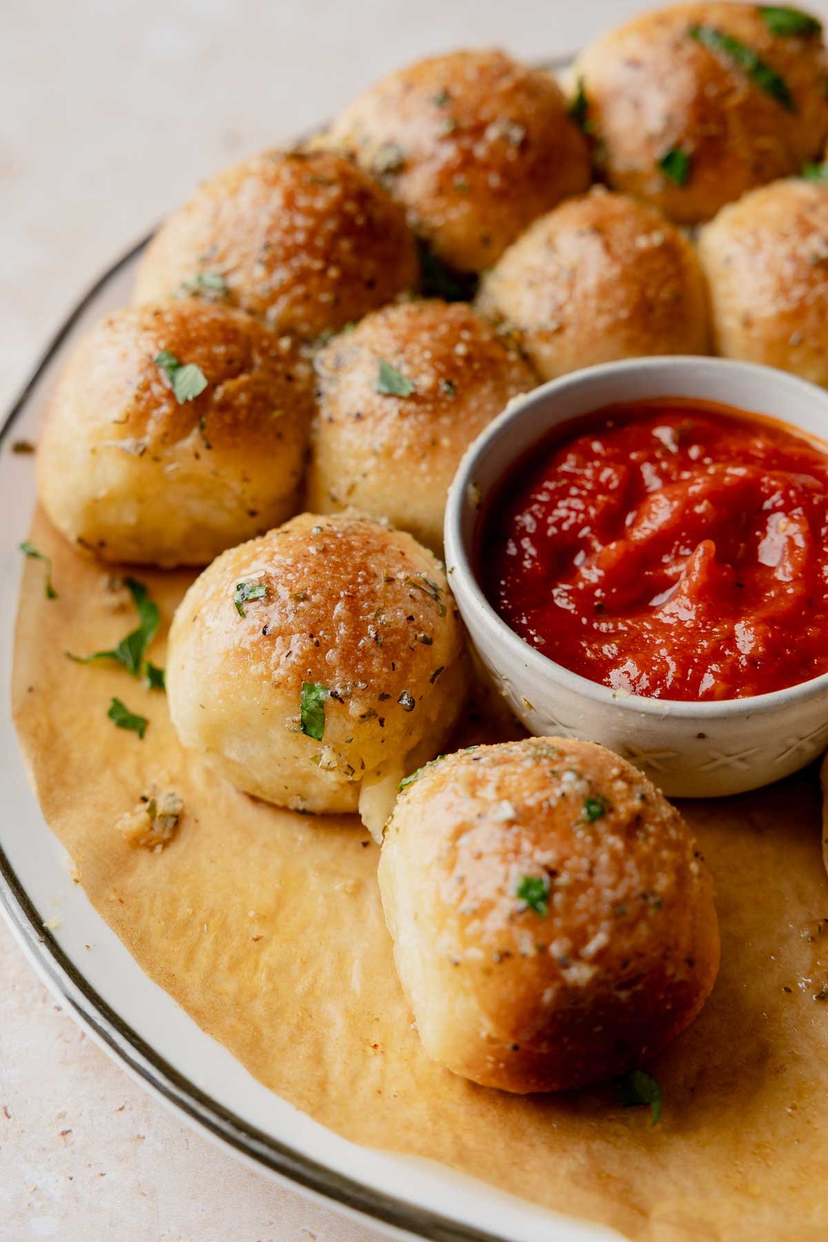Close-up of gluten-free garlic bread balls with marinara dipping sauce.