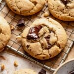 Baked peanut butter chocolate chip cookies cooling on a wire rack.