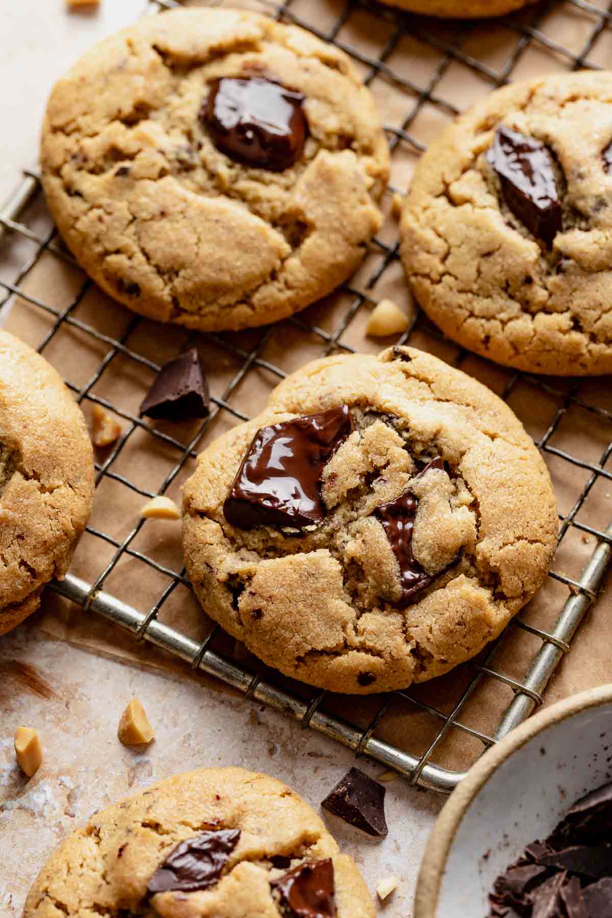 Baked peanut butter chocolate chip cookies cooling on a wire rack.