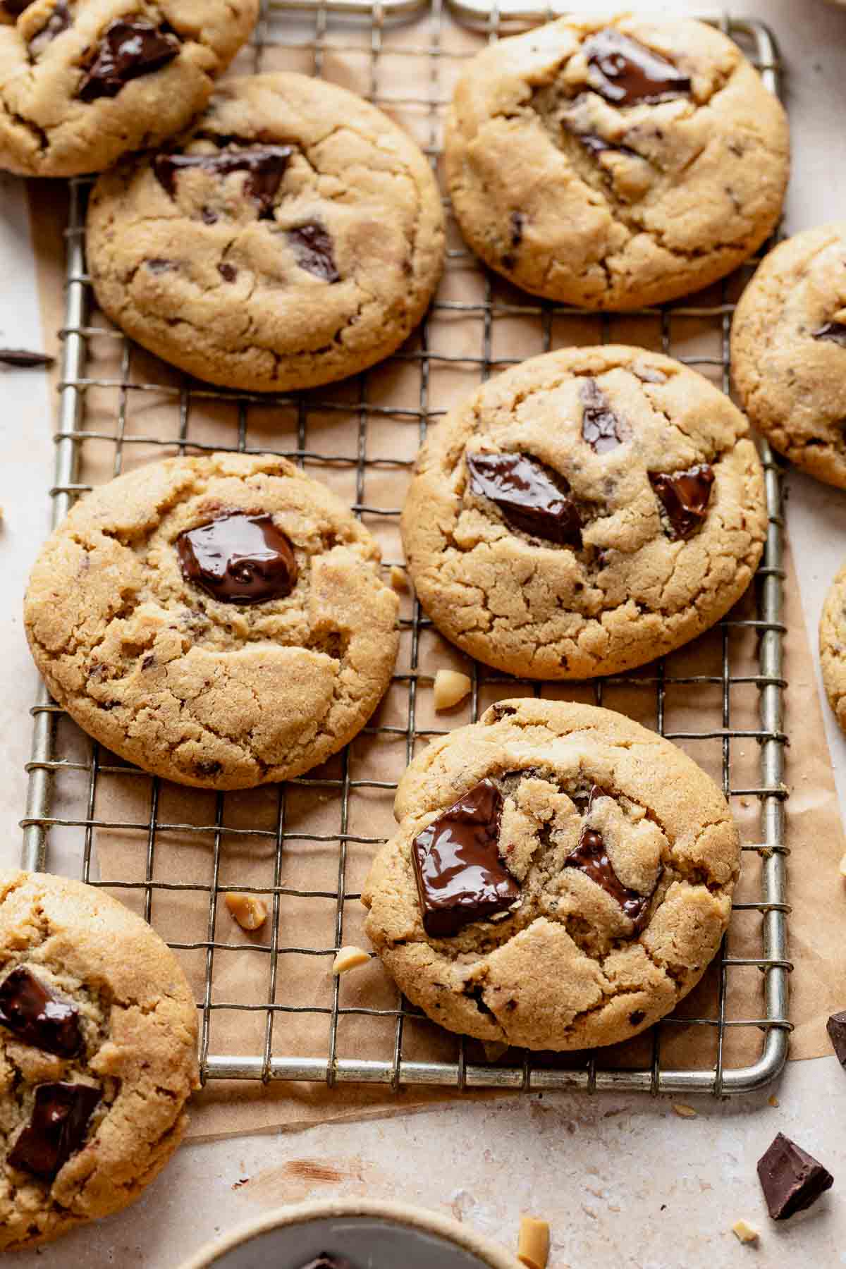 Several peanut butter chocolate chip cookies on a cooling rack.