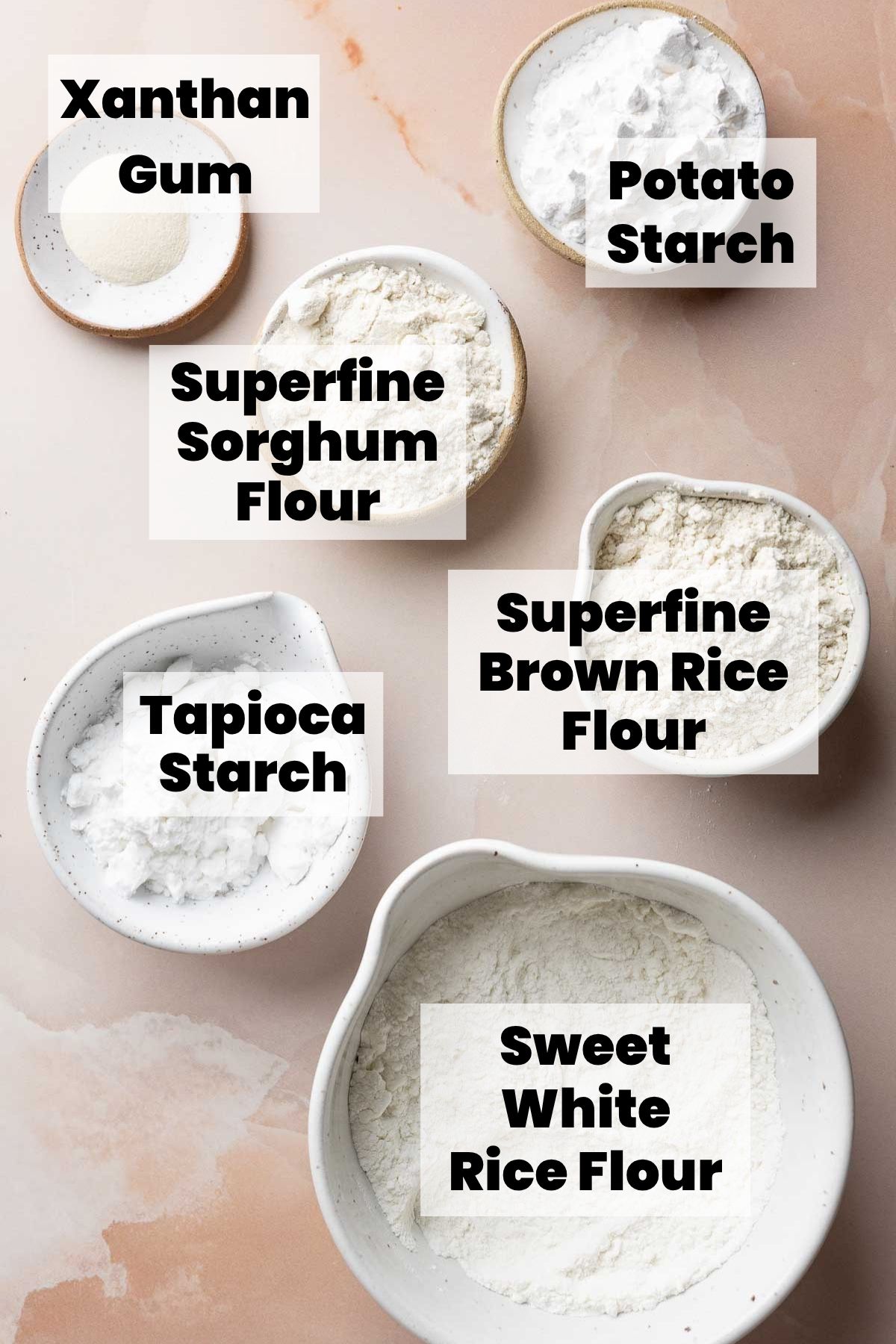 Bowls of labeled gluten-free flour blend ingredients.