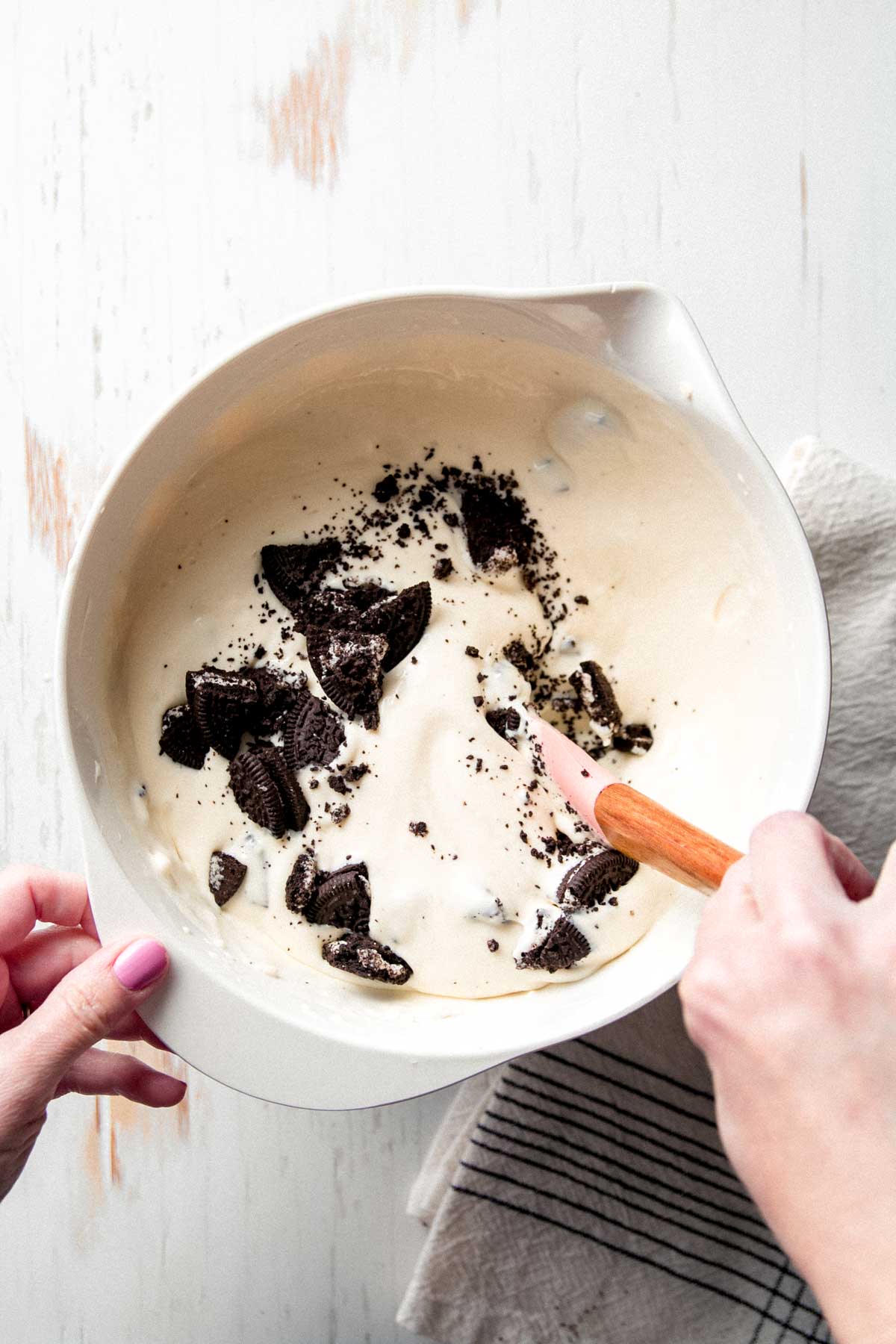 Folding in Oreo pieces.