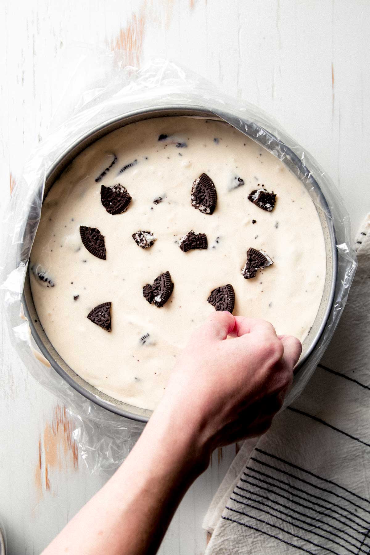 Placing more gluten-free Oreo chunks on top.