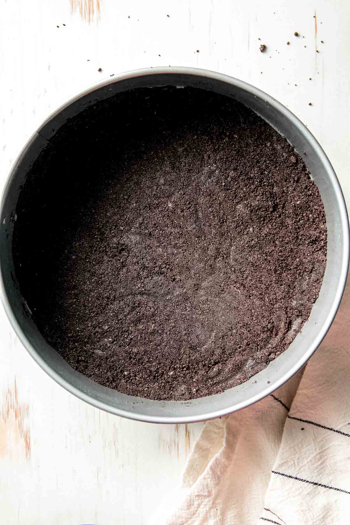 Gluten-free oreo crumbs pressed into springform pan.