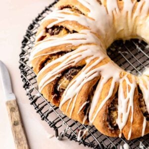 Iced gluten free Swedish tea ring cooling on a wire rack.