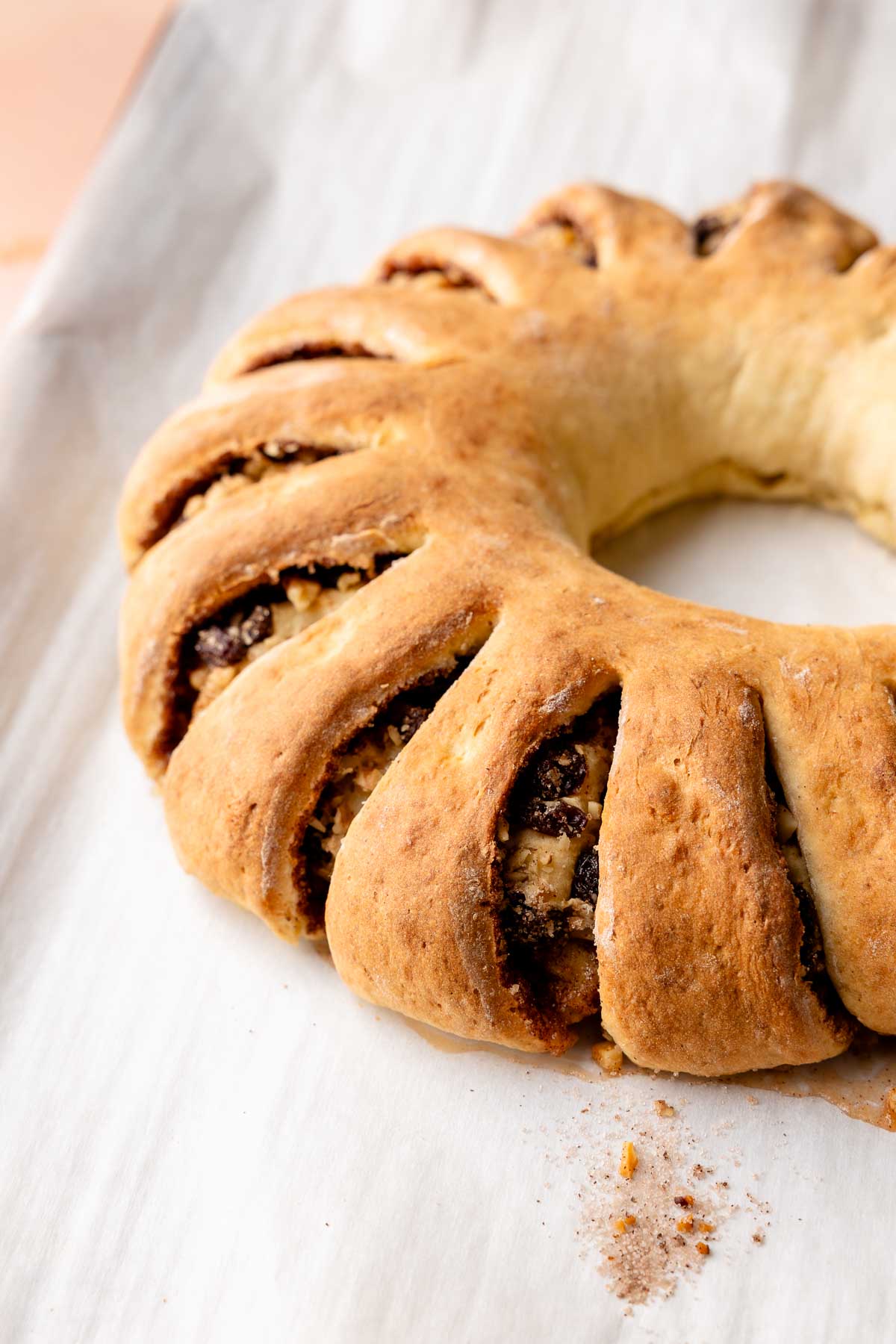 Tea ring on parchment paper baked and golden brown.