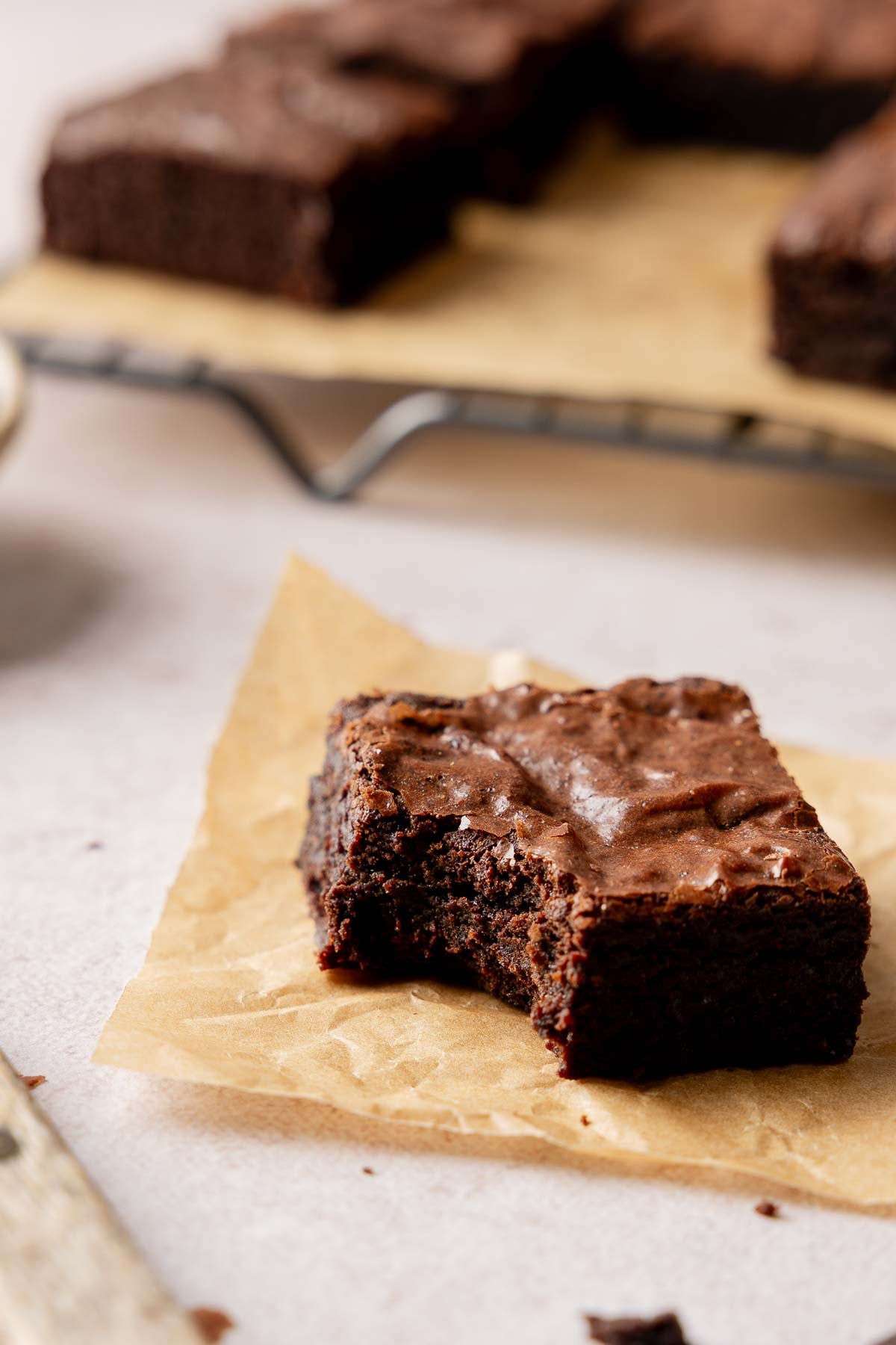 Fudgy gluten-free brownie with a bite taken.