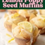 Lemon poppy seed muffins with glaze and lemon slice garnish on marble board.