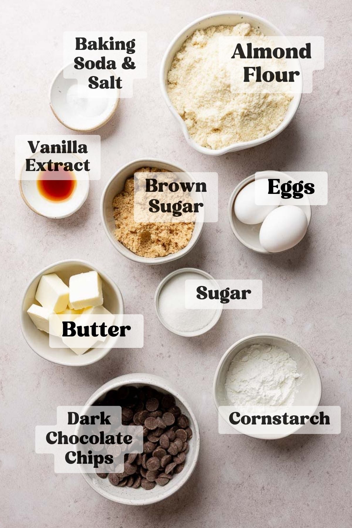 Ingredients for almond flour chocolate chip cookies measured out in bowls.