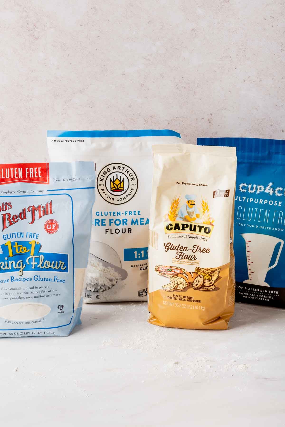 Bags of Bob's Red Mill, King Arthur, Caputo Fioreglut, and Cup4Cup gluten-free flour blends.