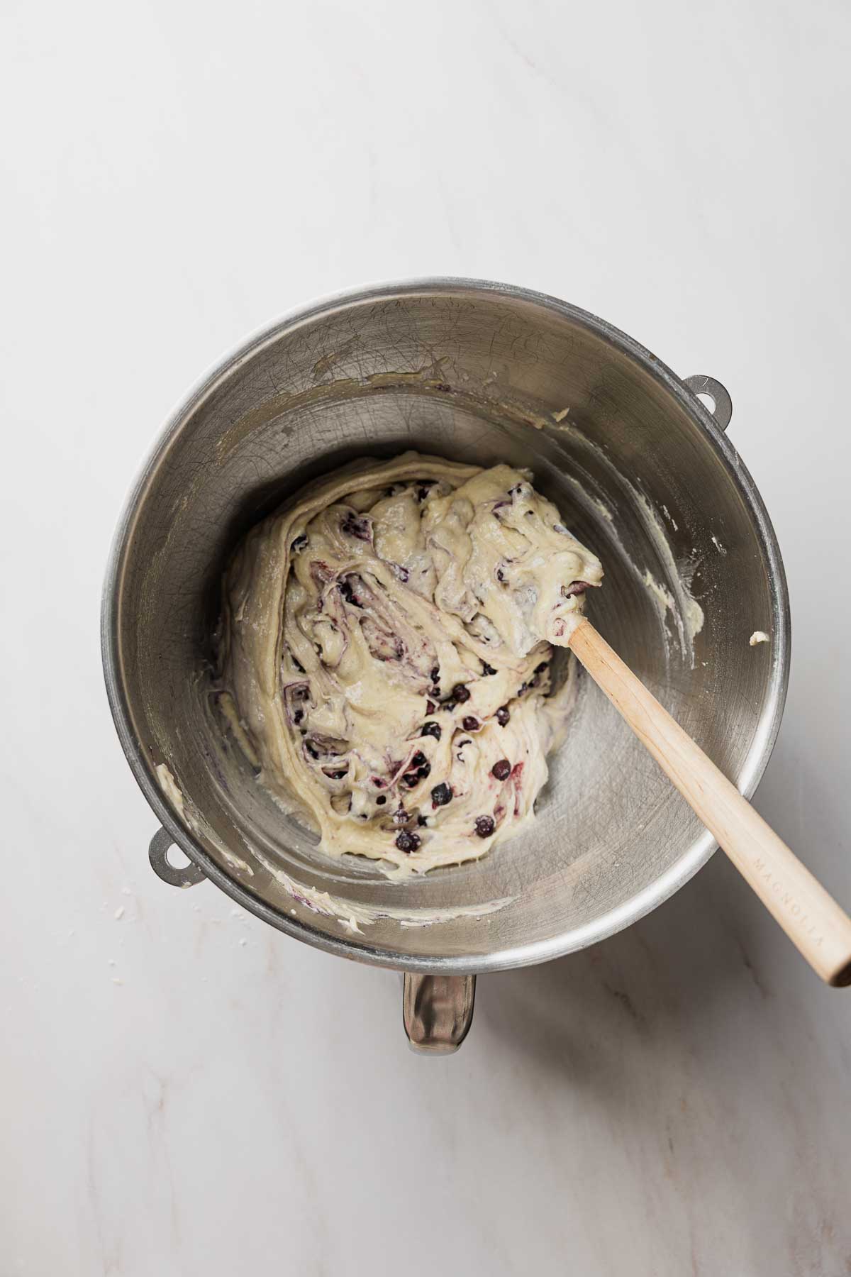 Blueberries folded into muffin batter with rubber spatula.