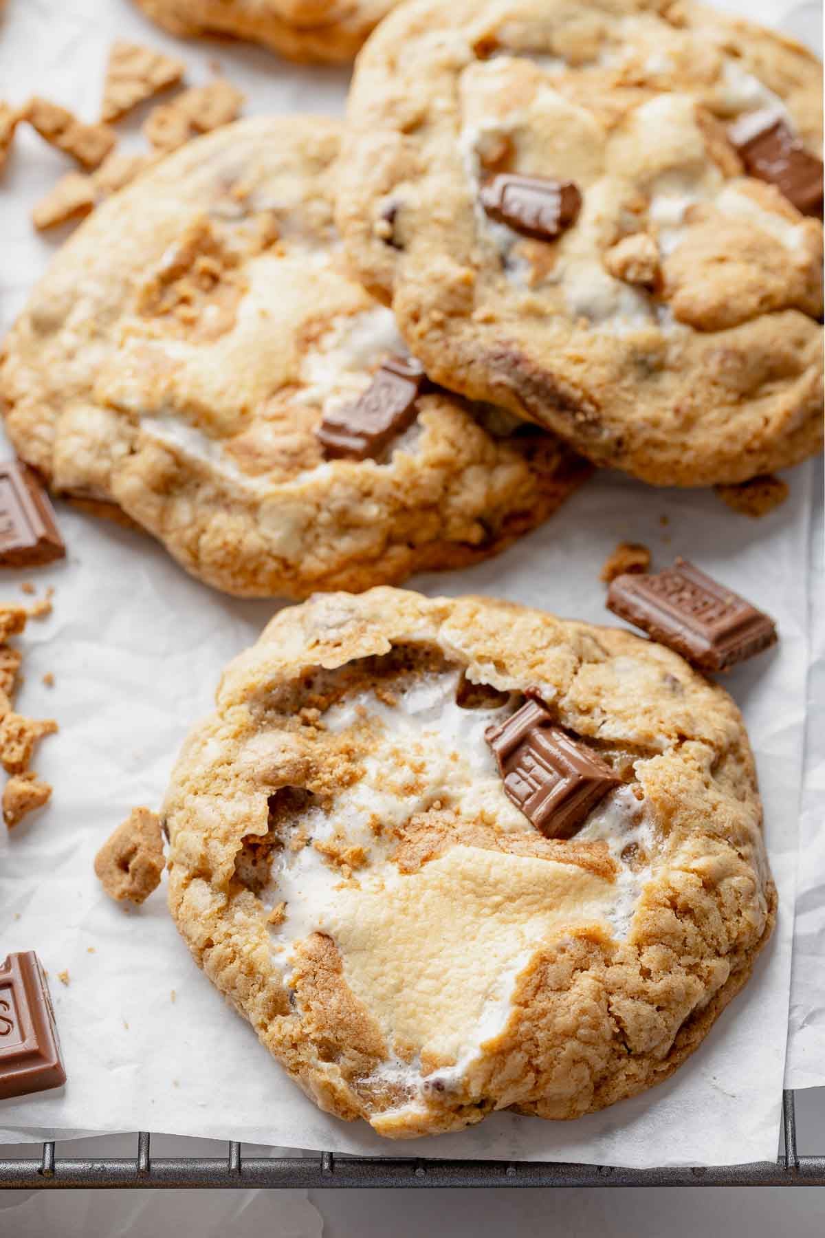 Gluten-free s'mores cookies on parchment paper liked cooling rack.
