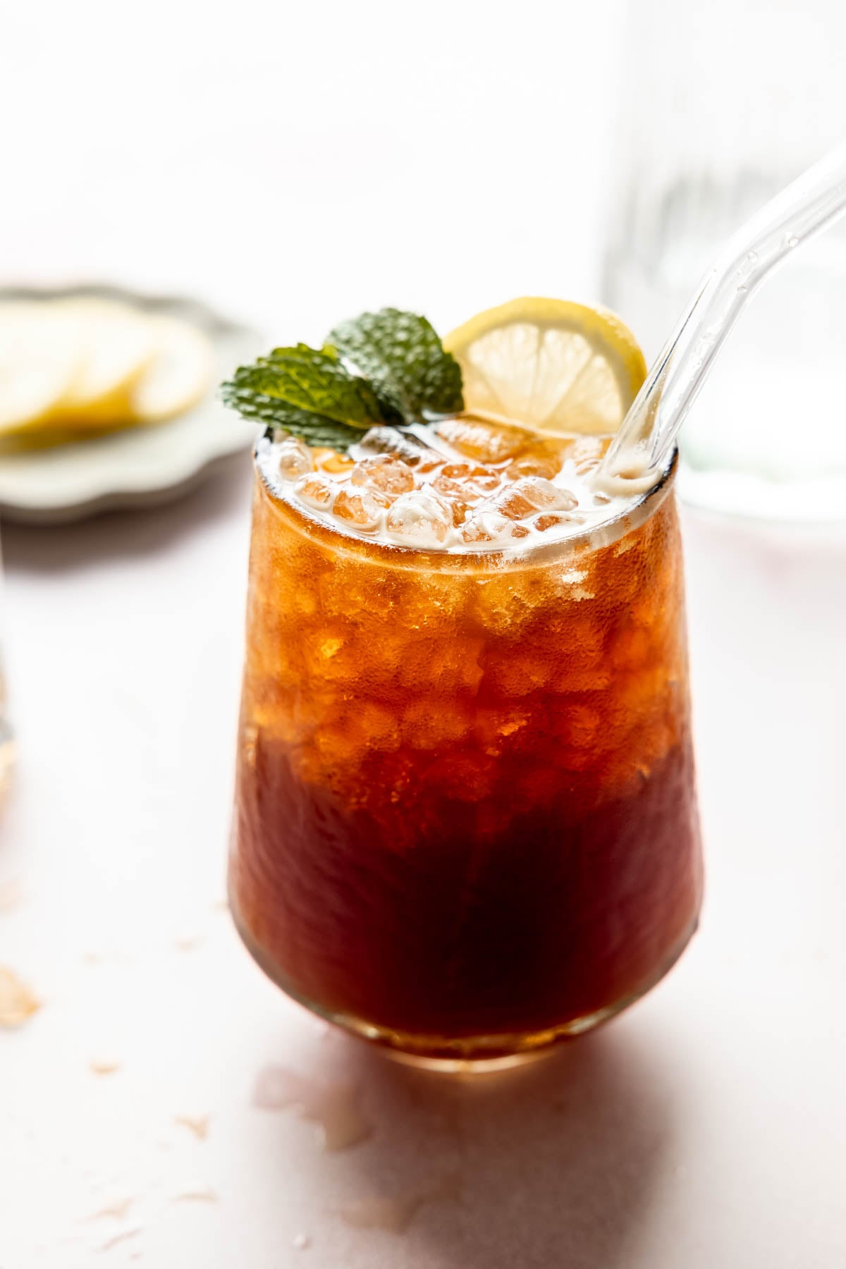 Sparkling Americano with ice, garnished with fresh mint and a lemon slice in a glass.