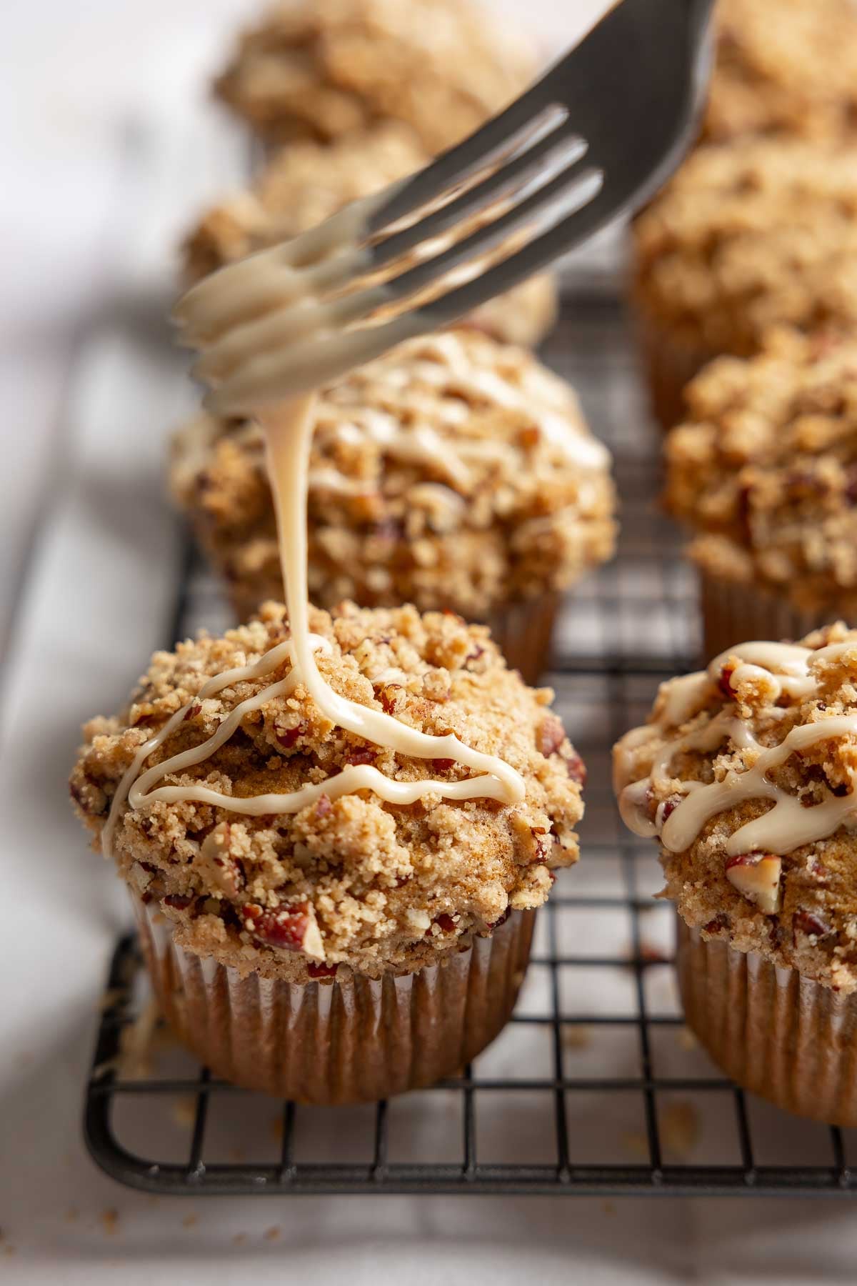 Maple glaze drizzled over pumpkin muffins.