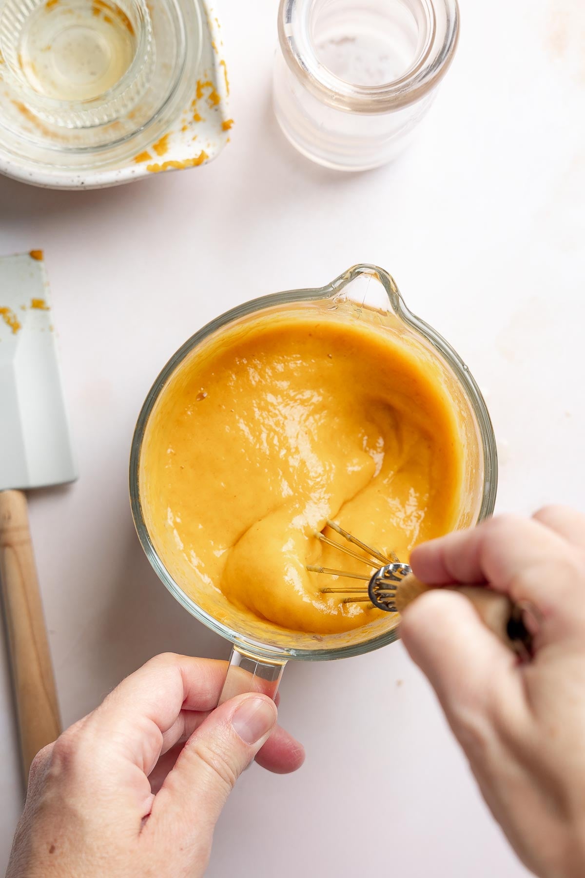 Blended wet ingredients for pumpkin muffins in small mixing bowl.