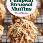 Gluten free pumpkin muffins topped with streusel and maple glaze lined up on wire rack.