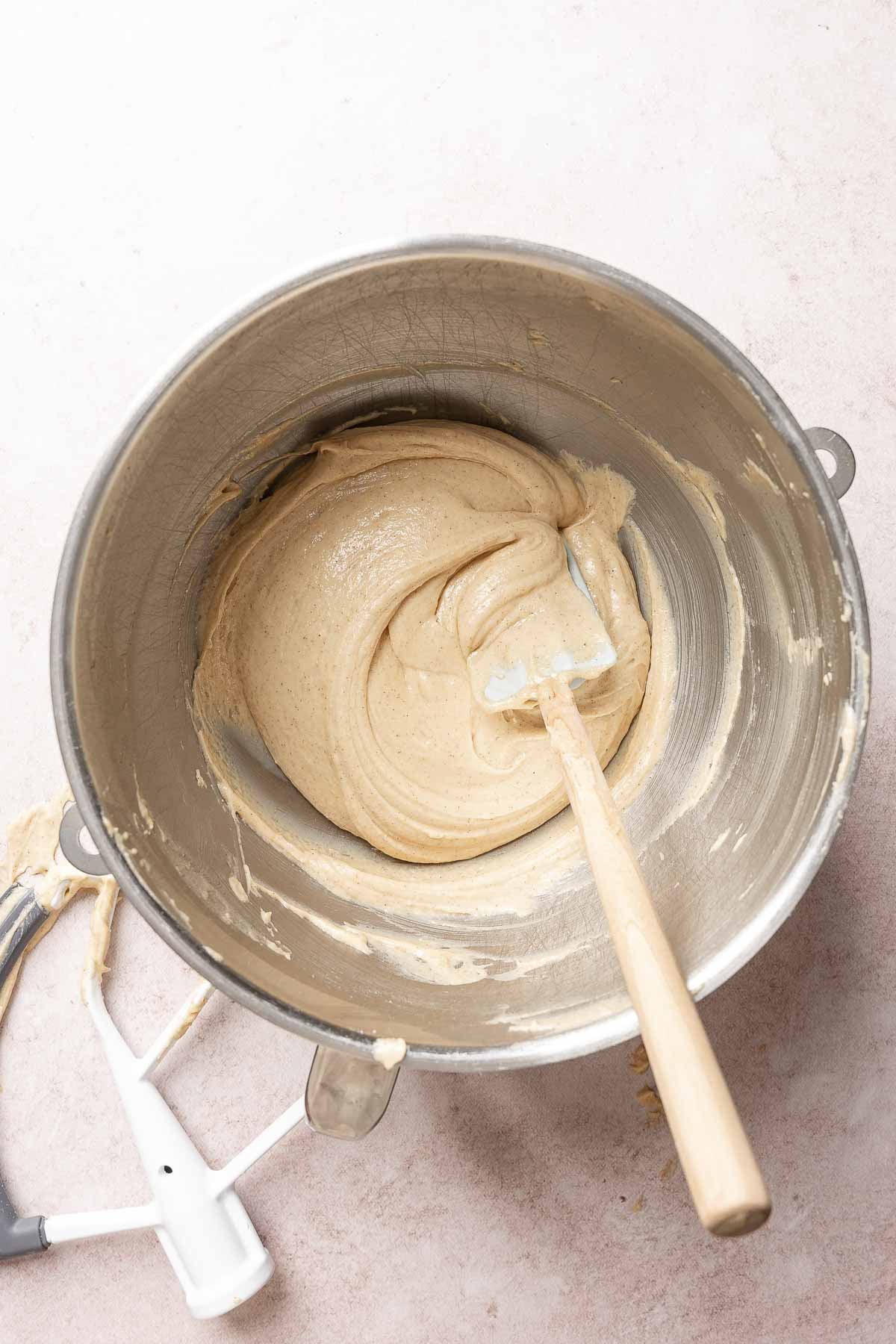 Muffin batter appears thick, resting in mixing bowl with spatula.