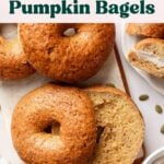 Gluten-free pumpkin bagels arranged on a small board.