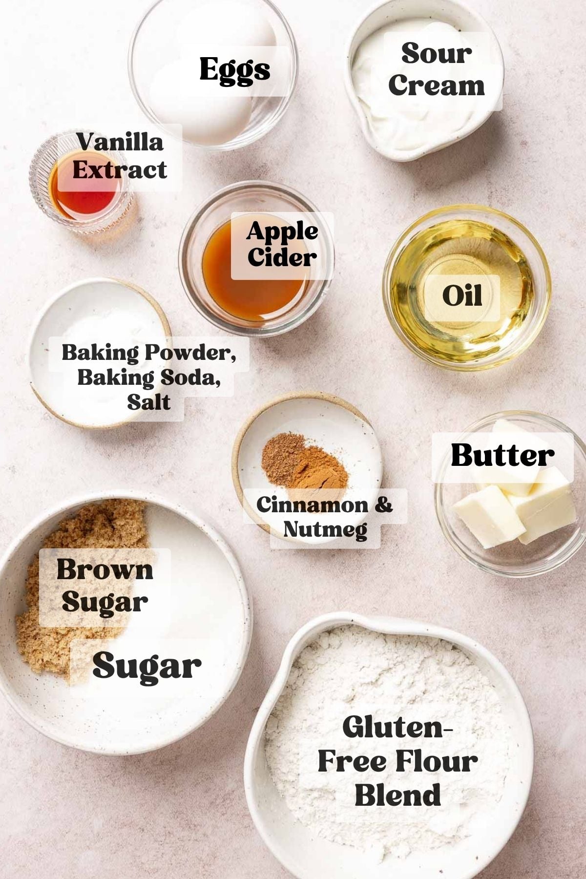 Ingredients for gluten free apple cider donut muffins measured out in bowls.